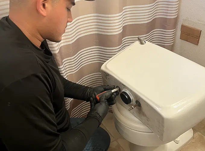 plumber repairing toilet plumber repairing toilet