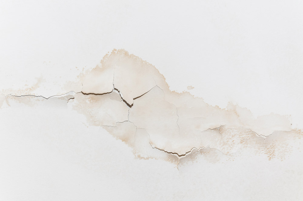 slab leak stains on concrete walls and floors