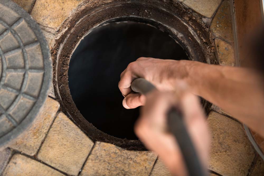 Trident technician hydro jetting a drain or sewer line