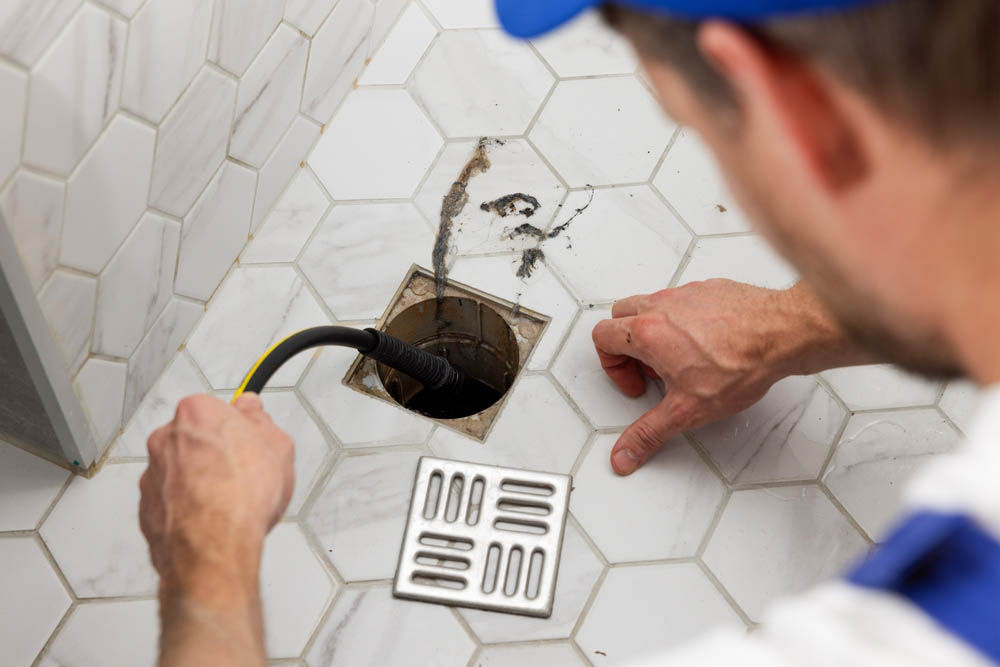 Trident technician hydro jetting a drain